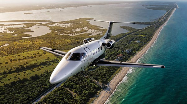 Embraer jet over a coastal location