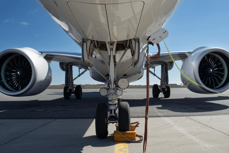 An Embraer aircraft photographed from underneath the front, looking towards the engines