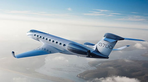 Gulfstream jet in a blue sky with a few clouds