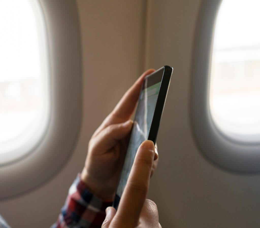 man using wifi on group air charter flight aircraft
