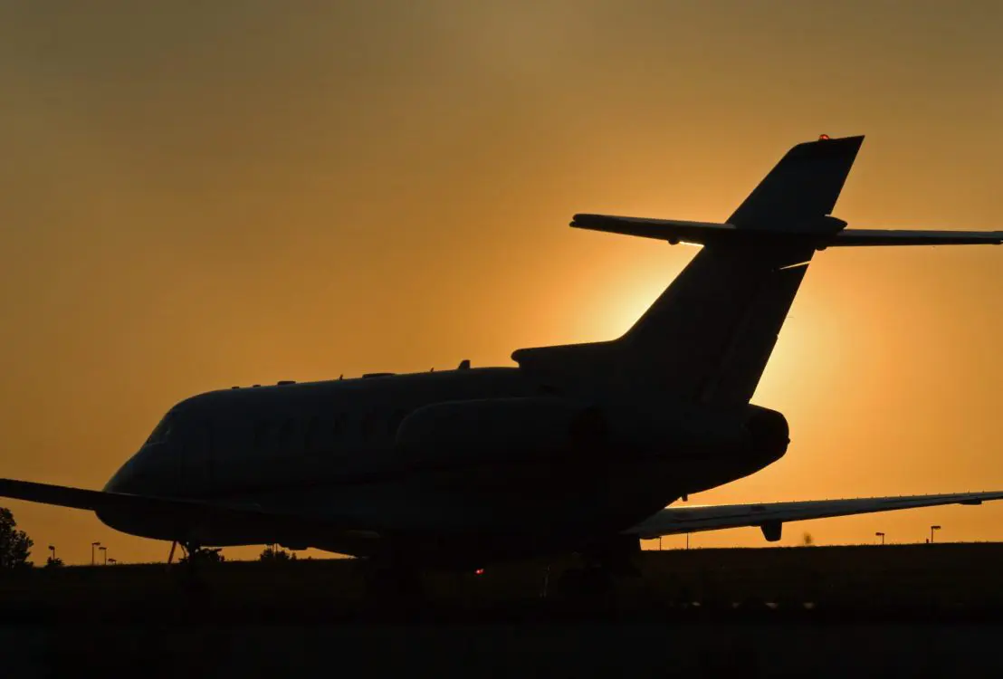 A private jet against sunset