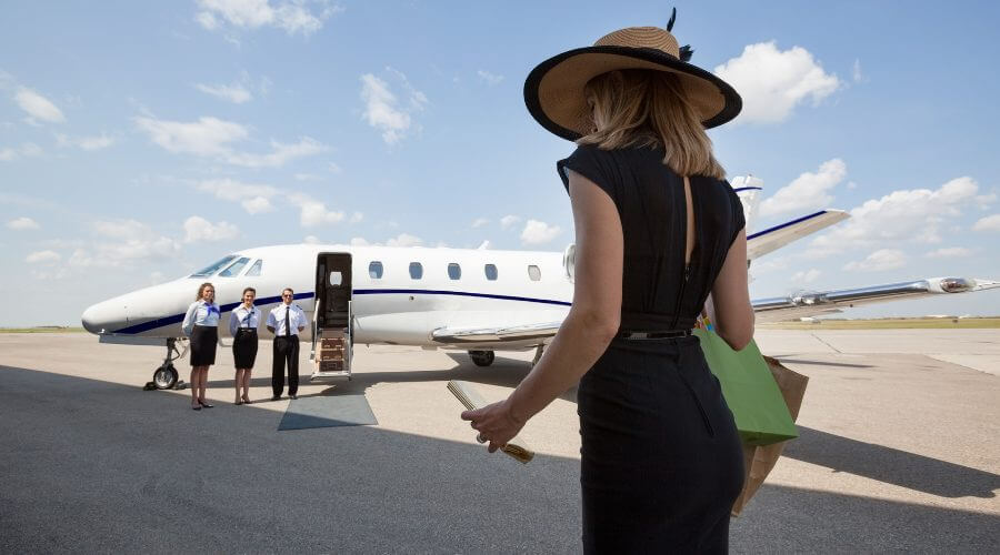 Lady walking across private terminal to private jet for fashion week