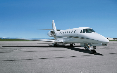 A private jet airplane on an airport runway 