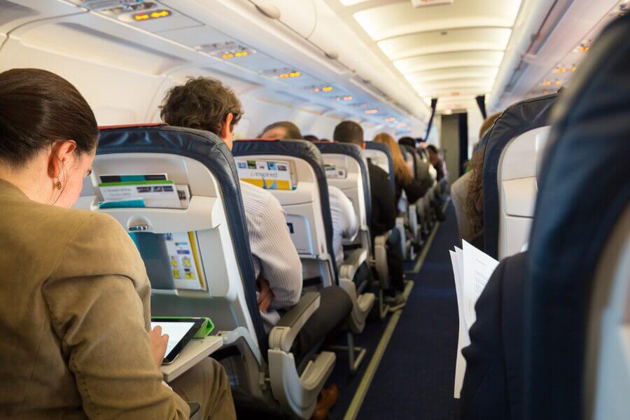 Business meeting in progress inside a private airplane, representing convenience of group air charters for corporate summer retreats.