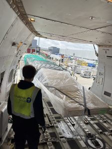 Heavy air cargo charter – oversized industrial equipment being nose-loaded into Boeing 747 freighter at Liège Airport