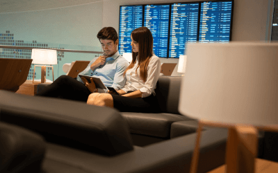 Young businessman and woman waiting comfortably in premier APAC airport lounge